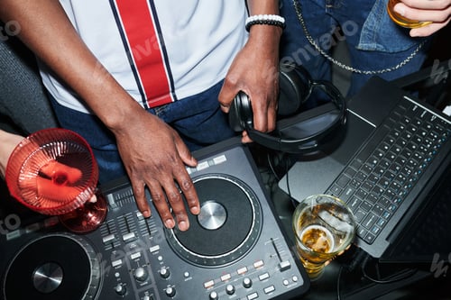 Preview: Young Black Man Mixing Music on Dj Controller at Nightclub Party