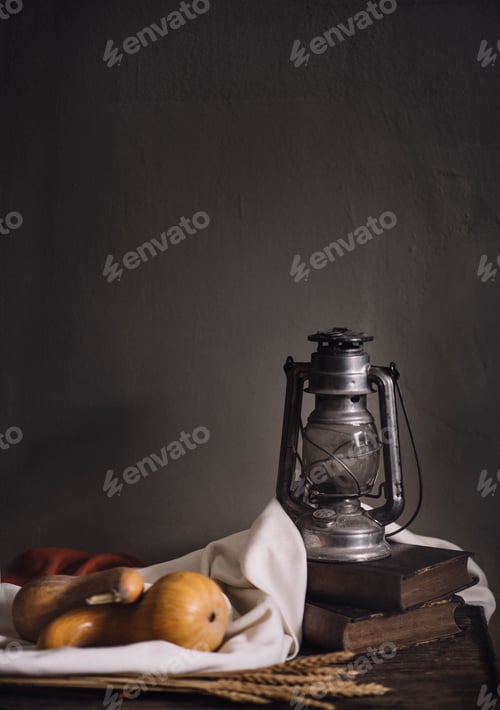 Preview: Autumn still life with vintage lantern and pumpkin vegetable on rustic wooden table.