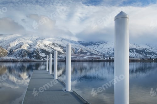 Preview: Pillars on dock at lake near snow covered mountain range