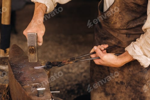 Preview: A blacksmith manually forges red-hot metal on an anvil with a hammer
