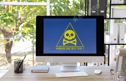 Preview: Computer with warning about virus attack on screen in office