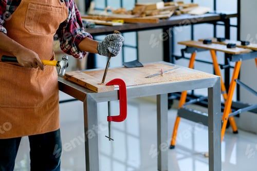 Preview: Craftsman or carpenter use hammer and chisel to work with wood