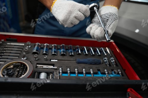 Preview: Close up photo of man holding car instruments