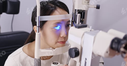 Preview: Woman do eye test at clinic