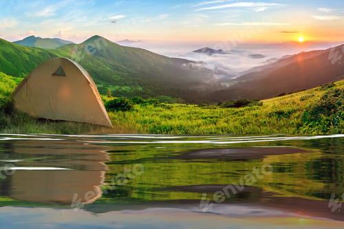 Preview: Tourist tent located in summer mountains at sunset. Hiking camp in evening nature. Travel and get