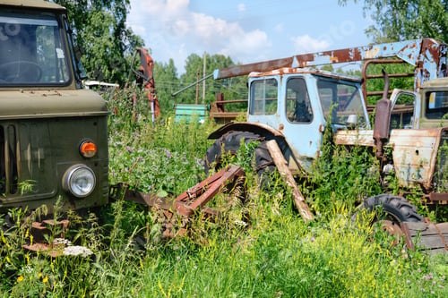Preview: rusty abandoned tractor. vintage old farming equipment.