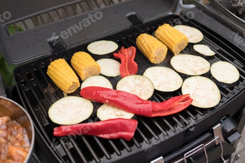 Preview: Grilled vegetables: corn, eggplant, and red peppers on outdoor barbecue grill