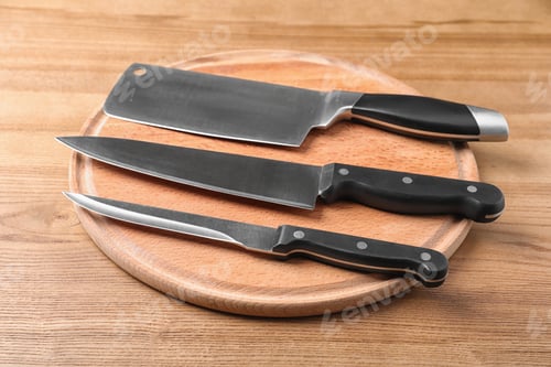 Preview: Board with set of knives on wooden background