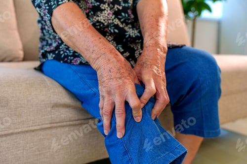 Preview: Senior woman experiencing severe knee pain at home