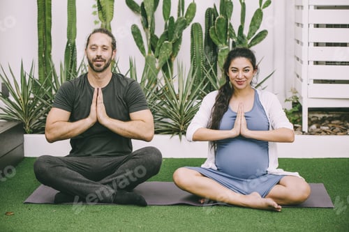 Preview: Relaxed Couple Meditating on Yoga Mat Outside