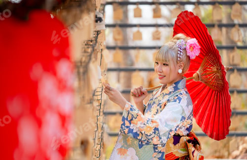 Preview: Portrait of pretty woman wear japanese style dress and hold red umbrella during attractive on banner