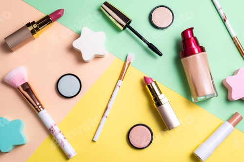 Preview: Makeup products and decorative cosmetics on color background flat lay