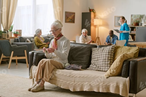 Preview: Senior Woman Using Knitting Set to Crochet