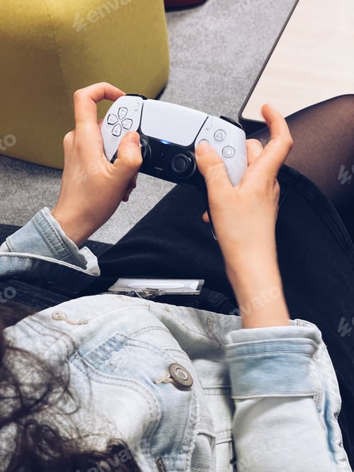 Preview: Woman holding in hands game controller and playing console games