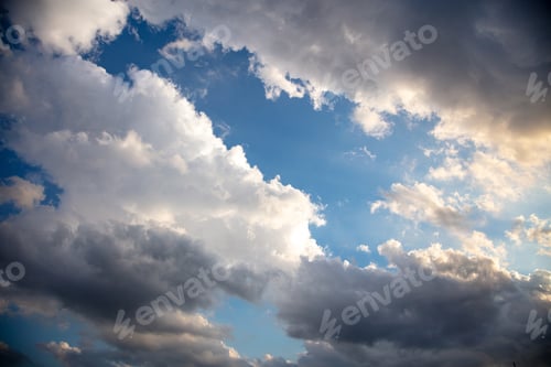 Preview: Fluffy cumulus clouds on blue sky background. Cloudscape white and grey color