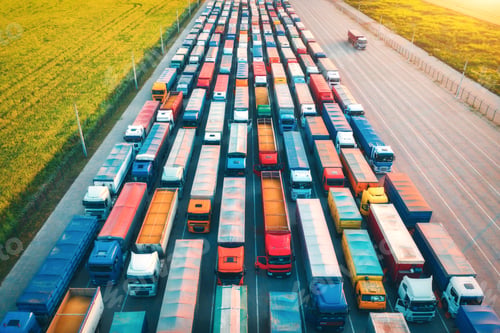 Preview: Aerial view of colorful trucks in terminal at sunrise in summer