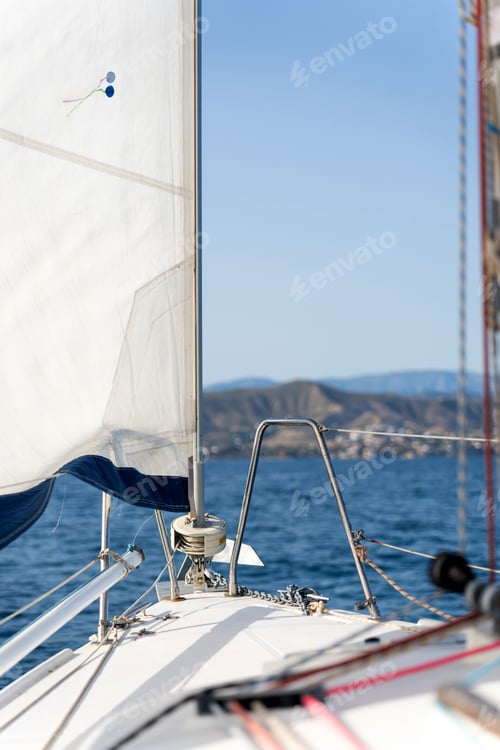Preview: Sailing on a sailboat towards the coast on a sunny day