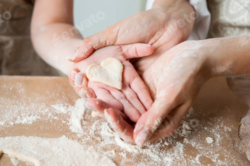 Preview: Heart shaped cookies in a child's hand in the kitchen. Cookie Cooking