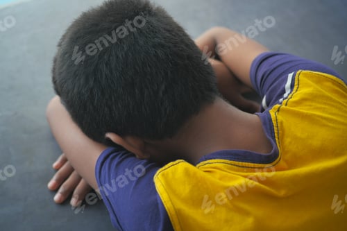 Vista previa: teenage boy head down on desk
