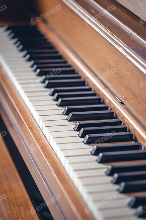 Preview: Piano keys on wooden brown musical instrument.