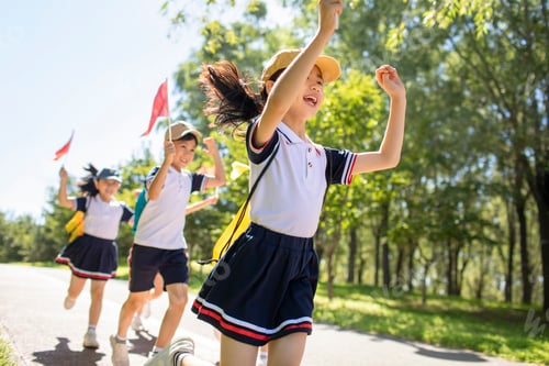 Preview: Cheerful Chinese school children relaxing in park