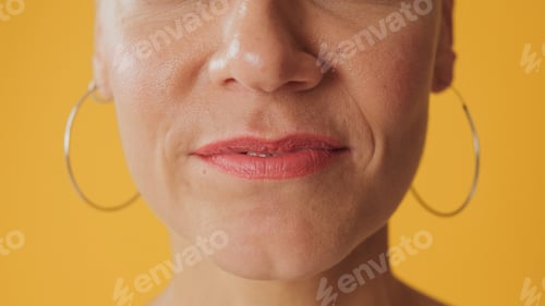 Preview: Detailed close-up shot of woman's lips isolated on yellow background