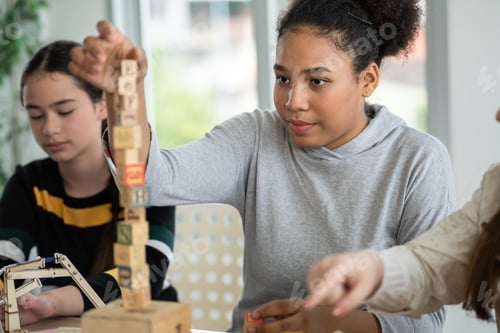 Preview: Student African girl playing with wooden block in the classroom