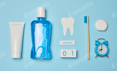 Preview: Mouthwash, toothpaste tube, dental floss on a blue background, oral hygiene.