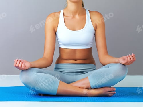 Preview: Cropped shot of an unrecognizable and sporty young woman meditating against a grey background