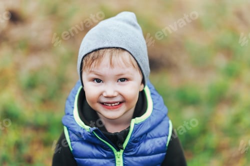 Preview: little blonde boy. Unusual appearance and heredity concept. boy is multiracial asian. outdoor walk