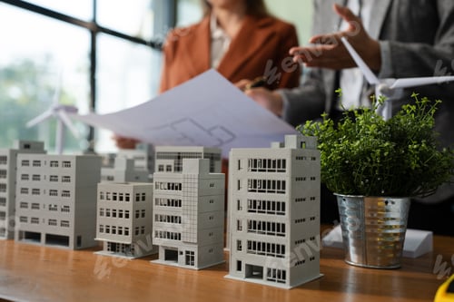 Preview: House model with agent asking costumer for contract to buy.