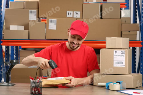 Preview: Post office worker with scanner reading parcel barcode at counter indoors