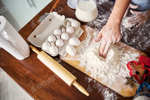 Preview: Skilled baker mixing flour for making dough