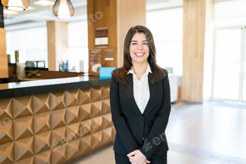 Preview: Confident Beautiful Clerk In Formalwear At Reception Area