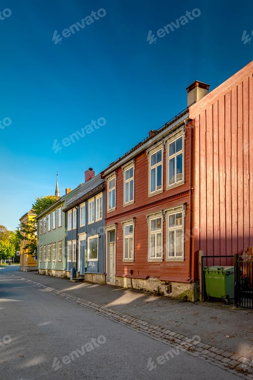 Preview: Vertical shot of colorful buildings on an old street in Trondheim, Norway