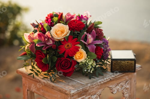Preview: Wedding reception wooden table with box for ring and flower composition with red and pastel roses
