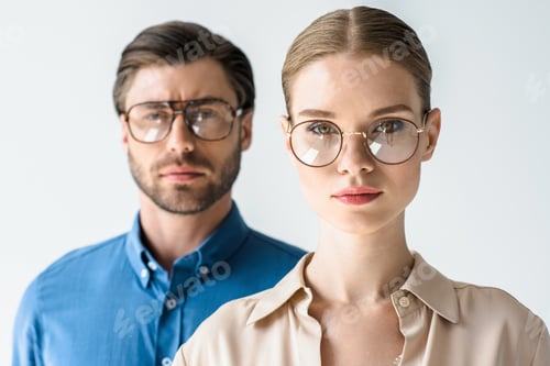 Preview: close-up portrait of attractive young man and woman in stylish clothing and eyeglasses isolated on