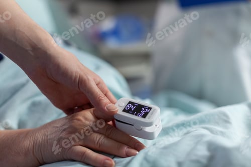 Preview: Close up of oxymeter attached on sick senior patient