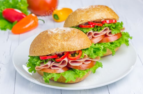Preview: Healthy ham sandwiches on the plate with vegetables on background