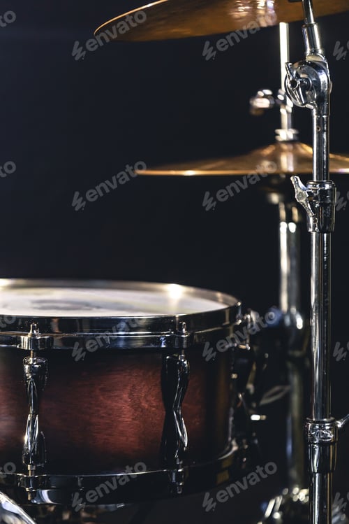 Preview: Snare drum on a blurred dark background, part of a drum kit.