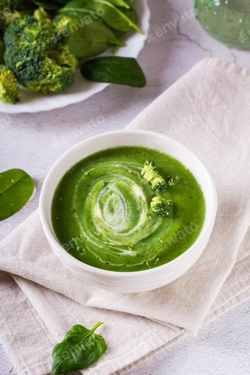 Preview: Bowl with broccoli cream soup on the table. Healthy food. Vertical view