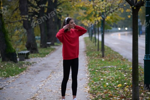 Preview: Athletic young woman taking a breath and relaxing after jogging and stretching. Woman Training and
