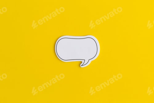 Preview: Paper speech bubble on a yellow background. Top view with copy space. Flat lay.