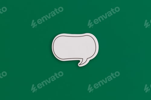 Preview: Paper speech bubble on a green background. Top view with copy space. Flat lay.