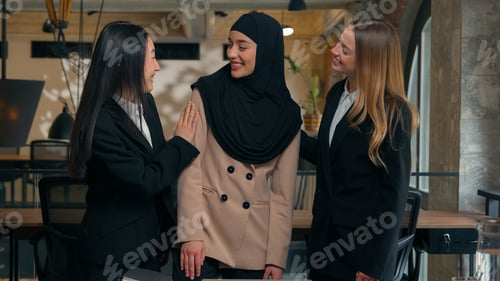 Preview: Happy laughing multiracial business co-workers female multiethnic colleagues businesswomen girls