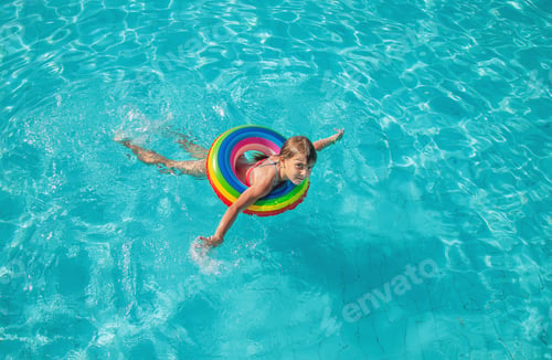 Preview: the child swims and dives in the pool. Selective focus.