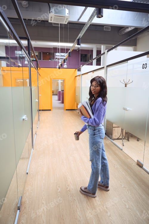 Preview: Attractive female looking at camera in hallway