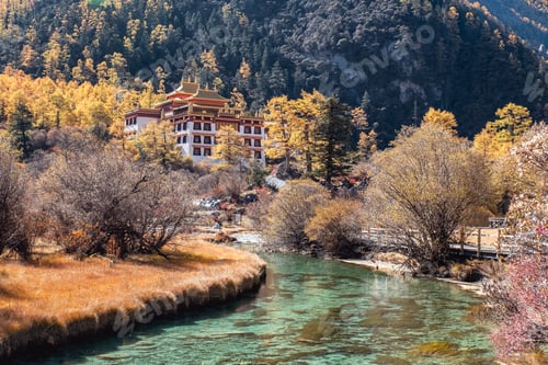 Preview: Chong Gu temple on autumn hill with emerald river at Yading
