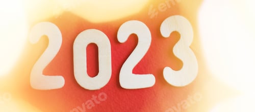 Preview: wooden number 2023 on christmas shiny gold and red background. sparkle festive blurred bokeh