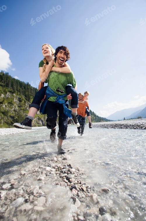 Preview: Germany, Bavaria, Tölzer Land, Men carrying young women piggyback